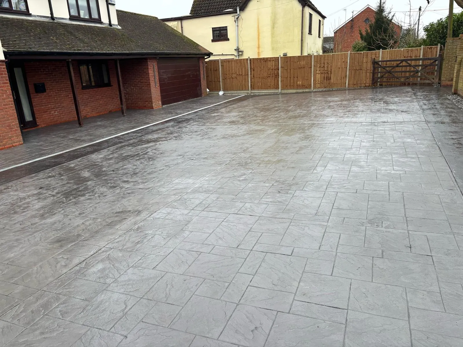 Pattern-imprinted concrete driveway by Urban Planet Construction
