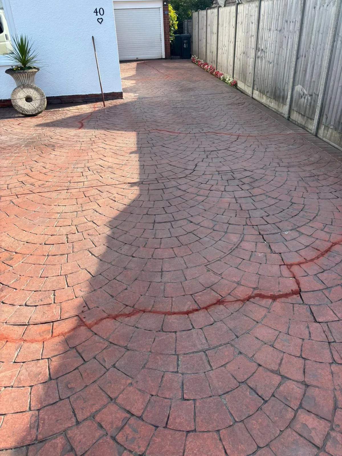 Pattern-imprinted concrete driveway by Urban Planet Construction