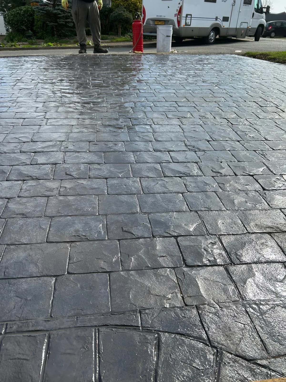 Pattern-imprinted concrete driveway by Urban Planet Construction