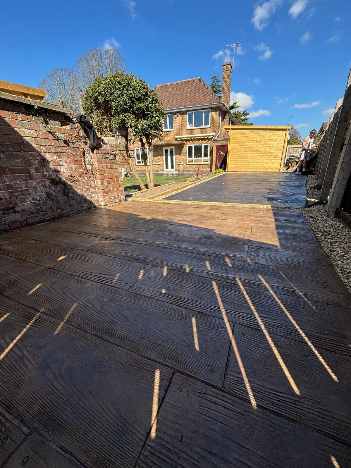 Pattern-imprinted concrete driveway by Urban Planet Construction