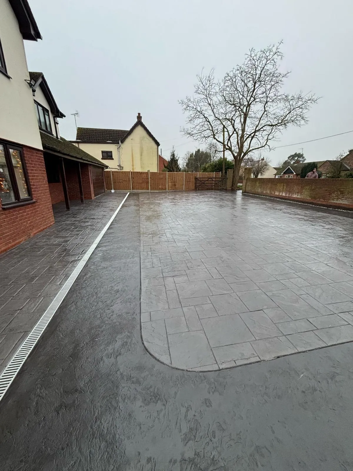 Pattern-imprinted concrete driveway by Urban Planet Construction
