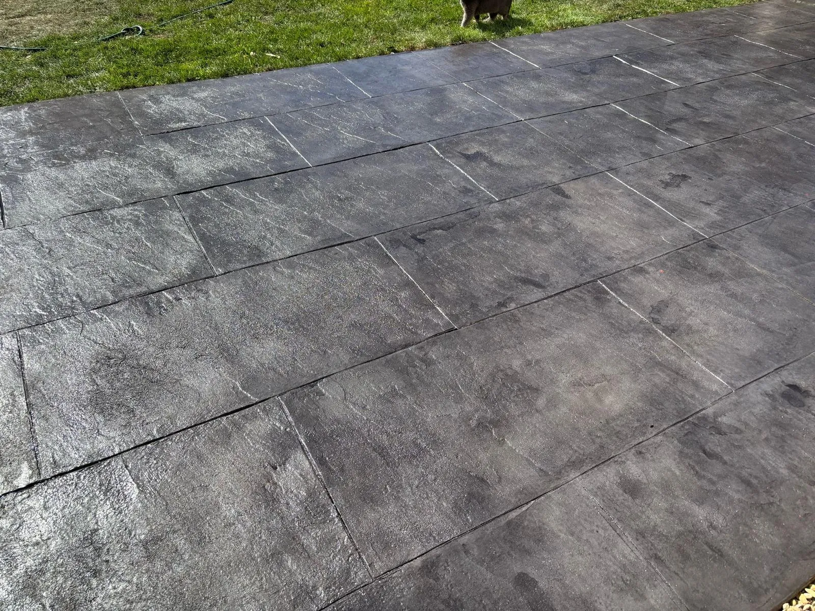 Pattern-imprinted concrete driveway by Urban Planet Construction