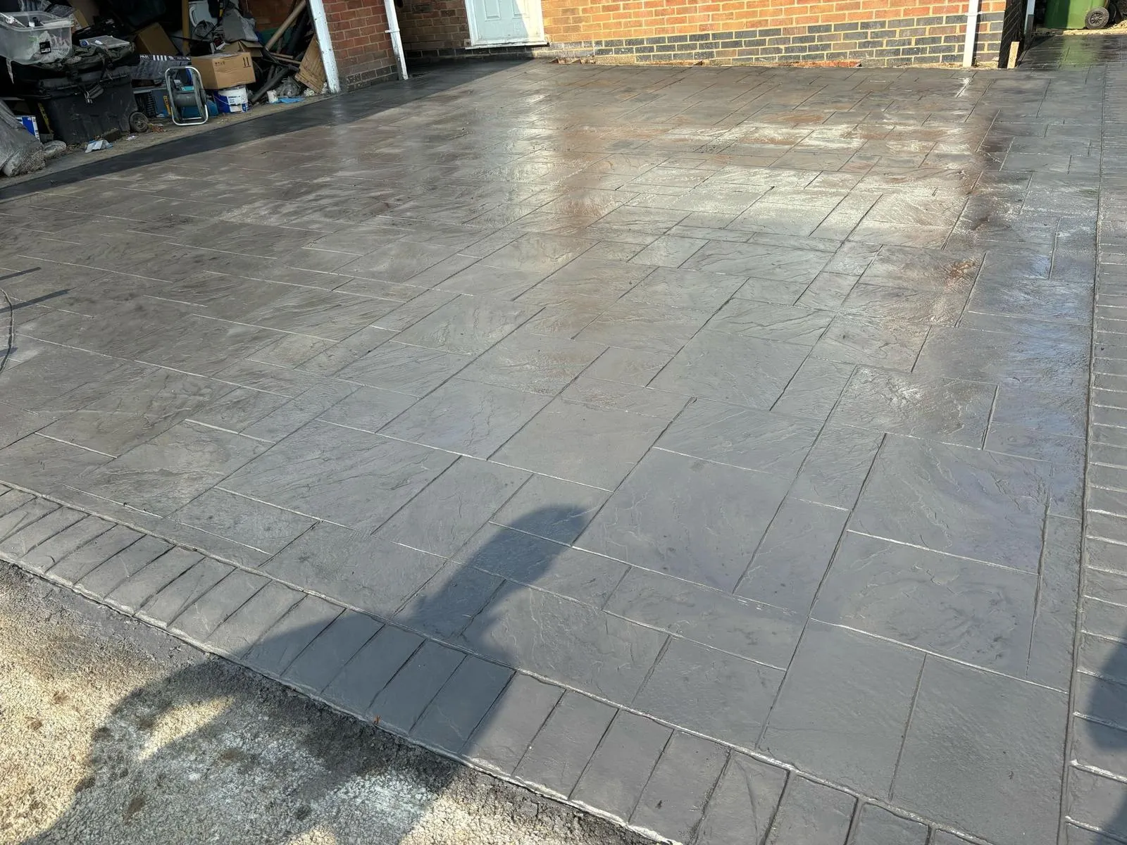 Pattern-imprinted concrete driveway in March by Urban Planet Construction