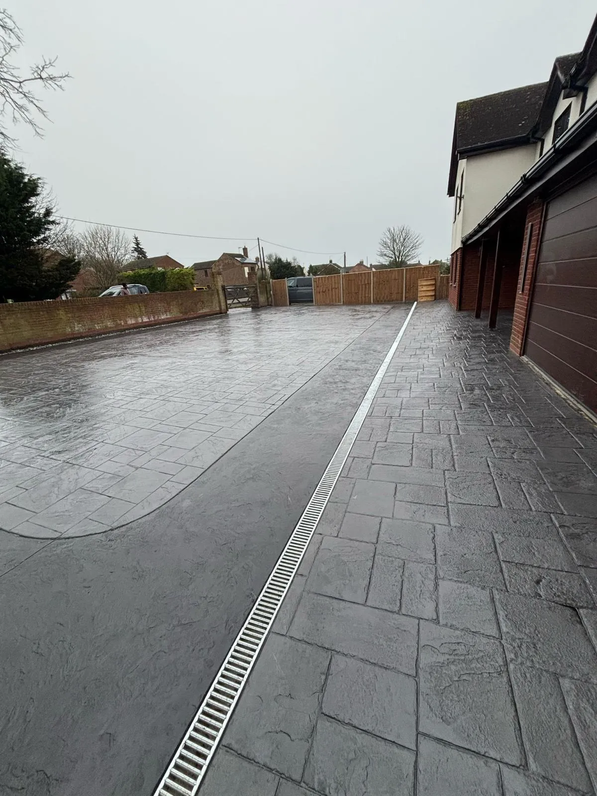 Pattern-imprinted concrete driveway in Ramsey by Urban Planet Construction