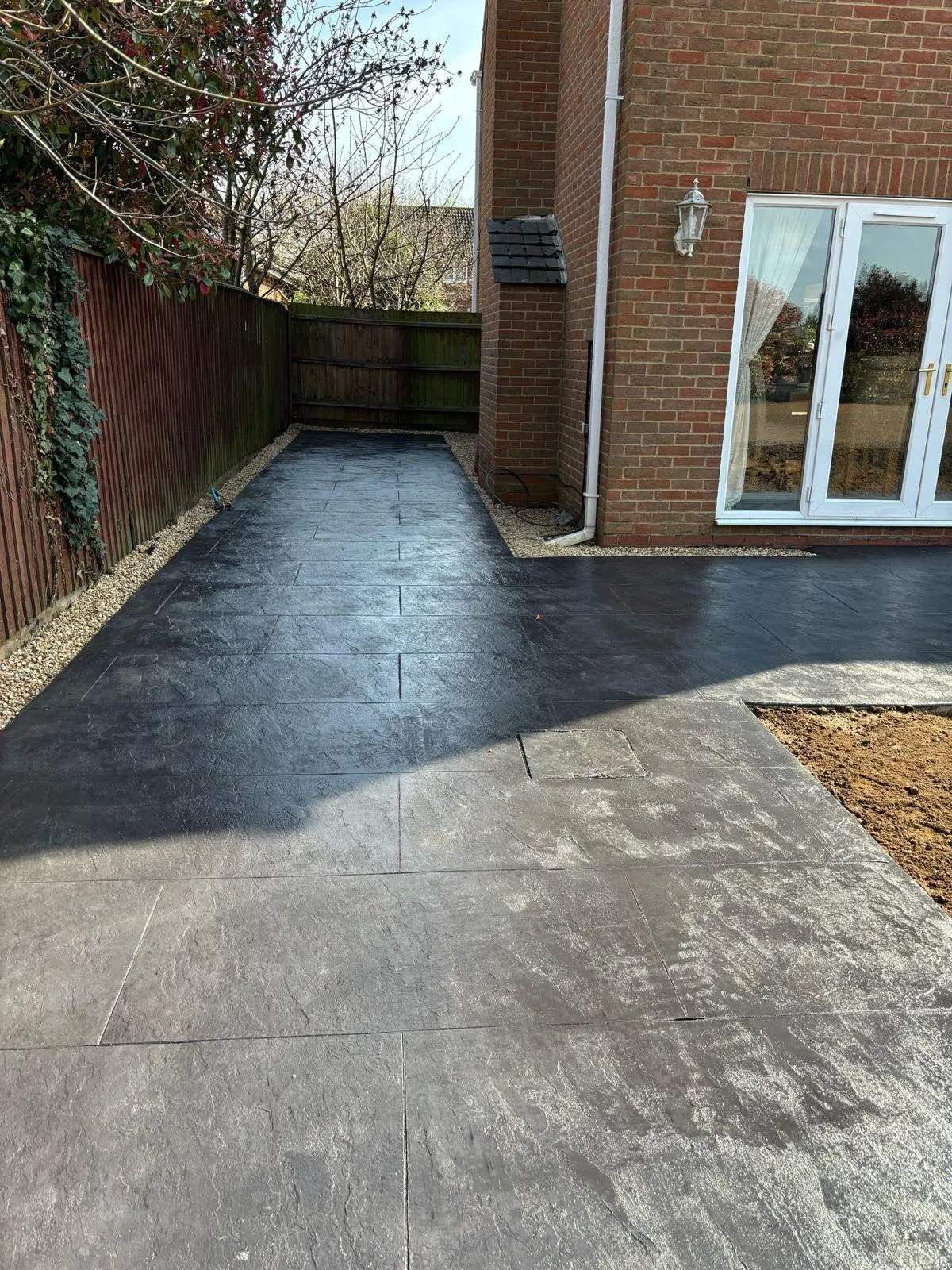 Pattern-imprinted concrete driveway by Urban Planet Construction