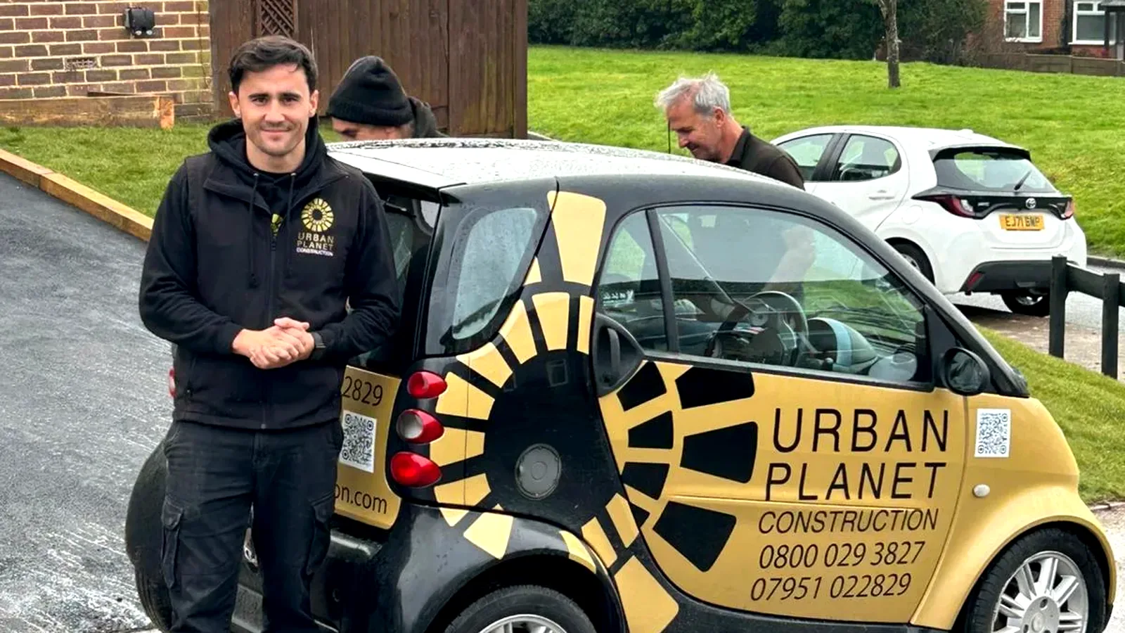 Cole Stevens beside the gold Urban Planet Construction branded car on a finished driveway