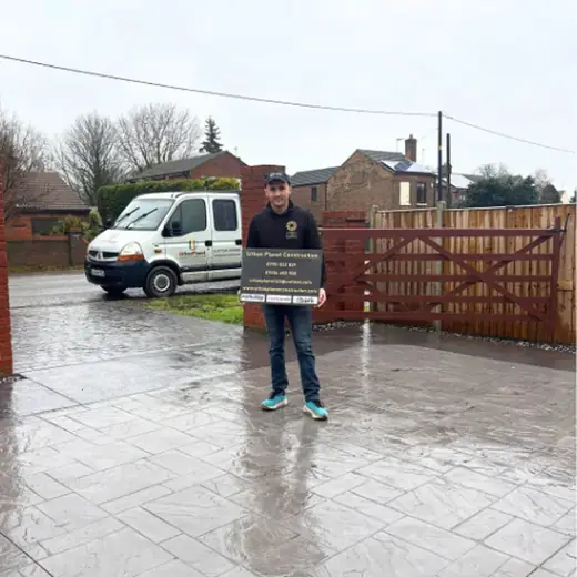 Cole Stevens, owner of Urban Planet Construction, beside the company van
