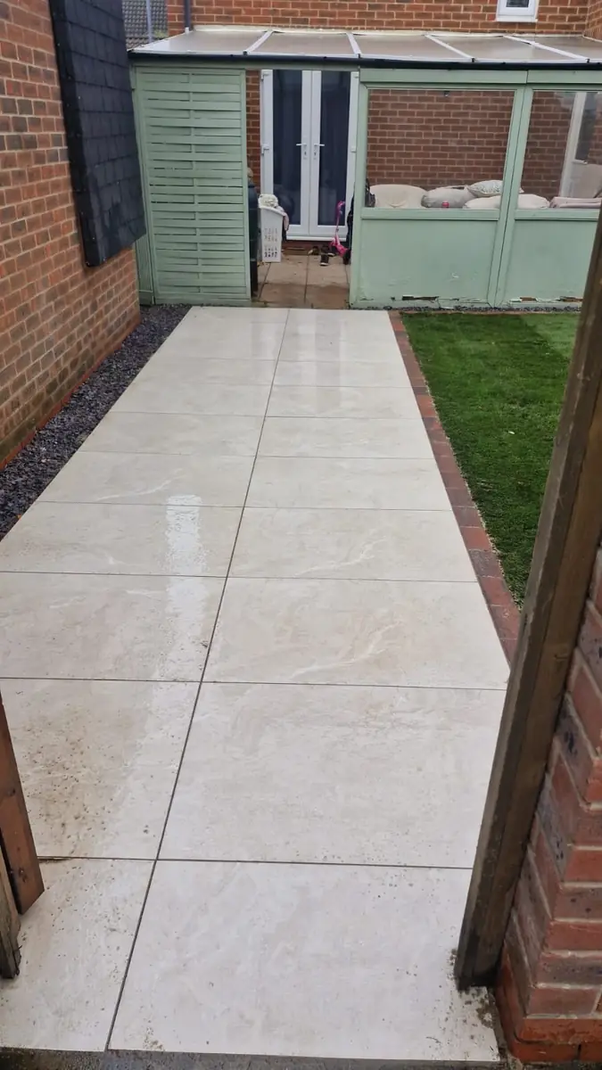 Porcelain path laid up to a summerhouse, with new turf alongside